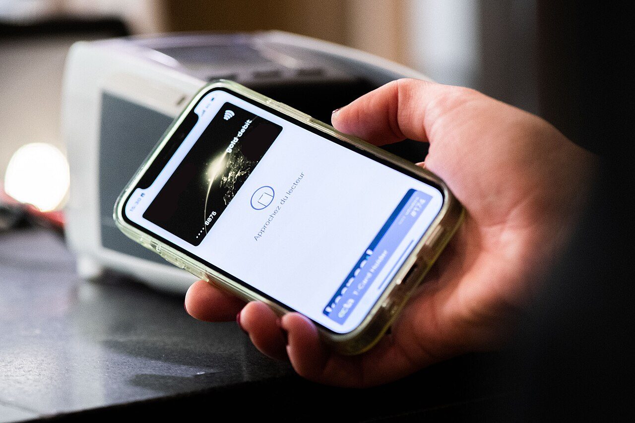 A person using a smartphone to make a payment.