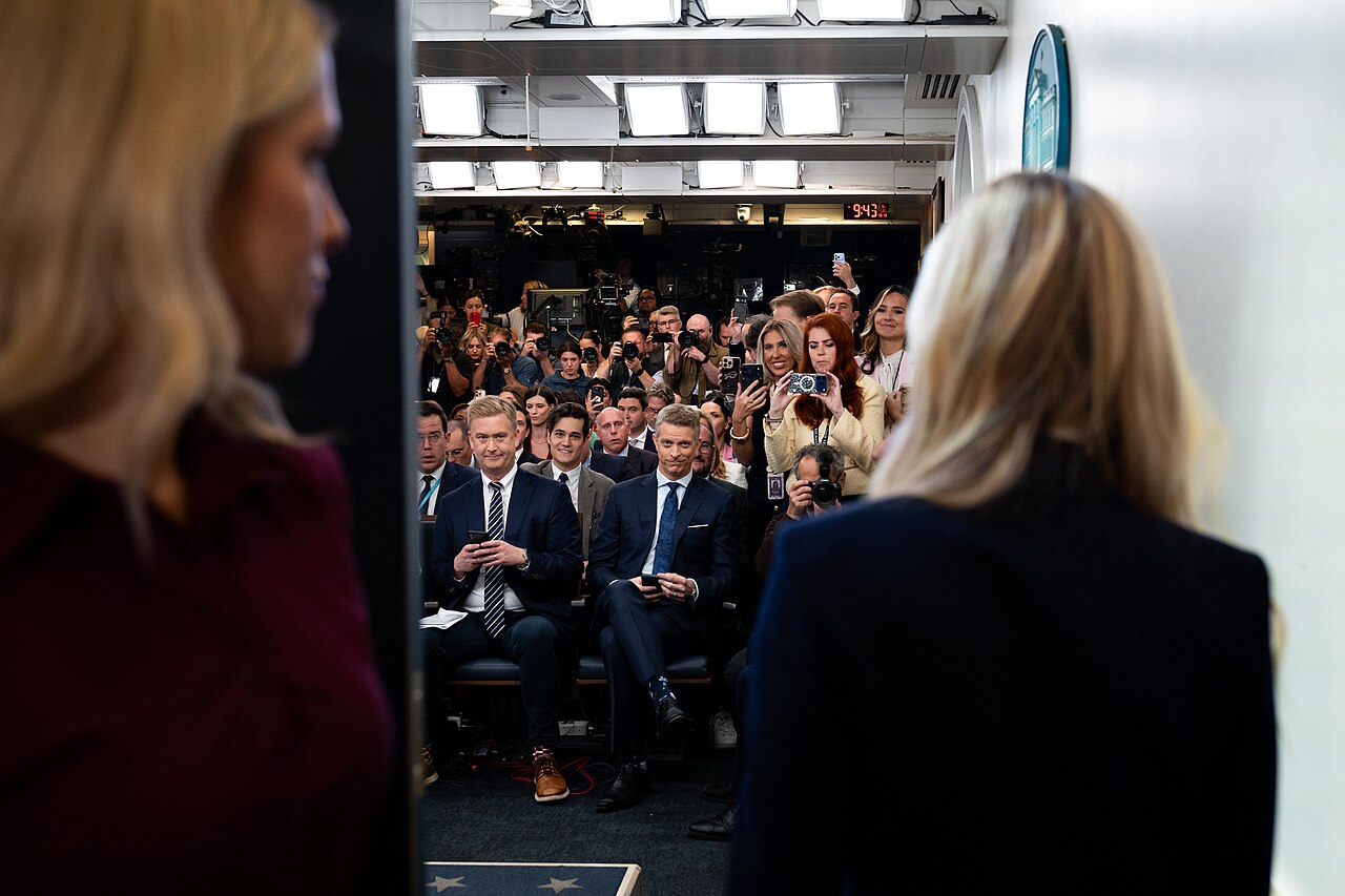 Katie Zacharia at the podium in the James S. Brady Press Briefing Room