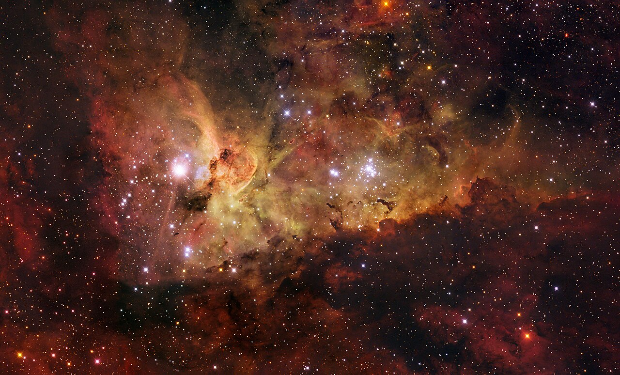 The Carina Nebula, a large bright nebula that surrounds several clusters of stars, located 7500 light years away.