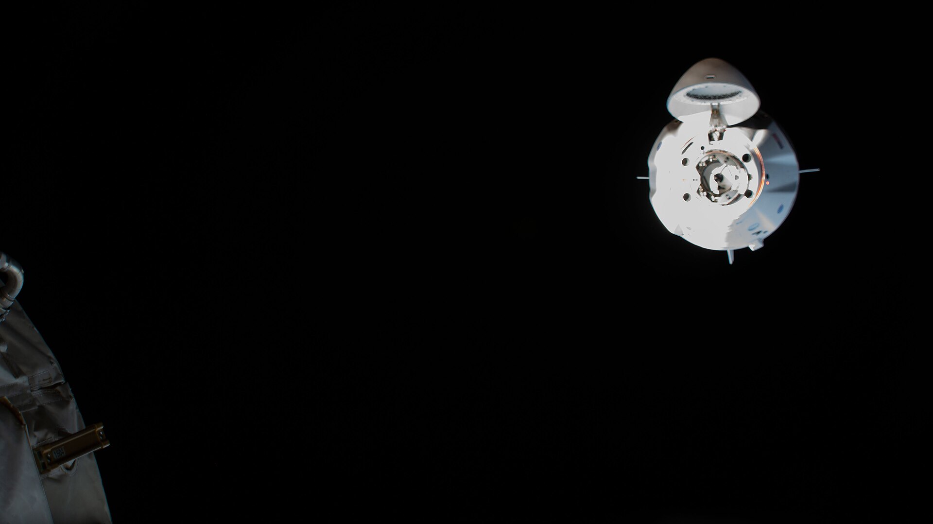 The SpaceX Crew Dragon "Resilience" is pictured approaching the International Space Station's international docking adapter on the forward port of the Harmony module.